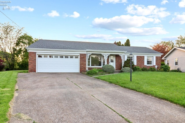 single story home featuring brick siding, a garage, driveway, a front lawn, and a shingled roof