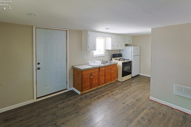 108 Spring St, Willard, OH 44890 - kitchen featuring white appliances, dark wood-style floors, light countertops, white cabinetry, and recessed lighting