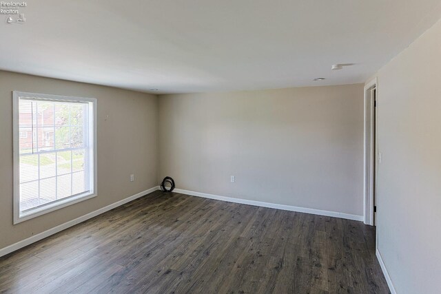 108 Spring St, Willard, OH 44890 - unfurnished room with dark wood-type flooring and baseboards