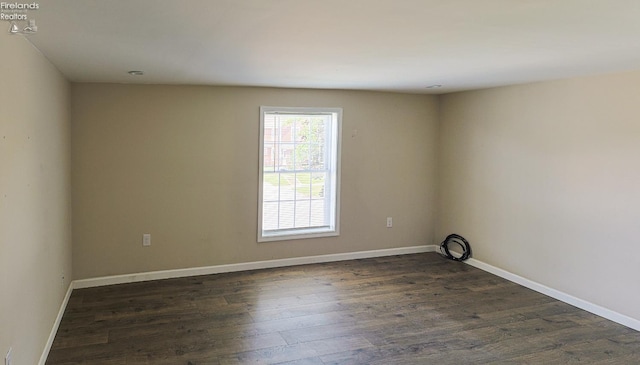 108 Spring St, Willard, OH 44890 - empty room featuring dark wood-type flooring and baseboards