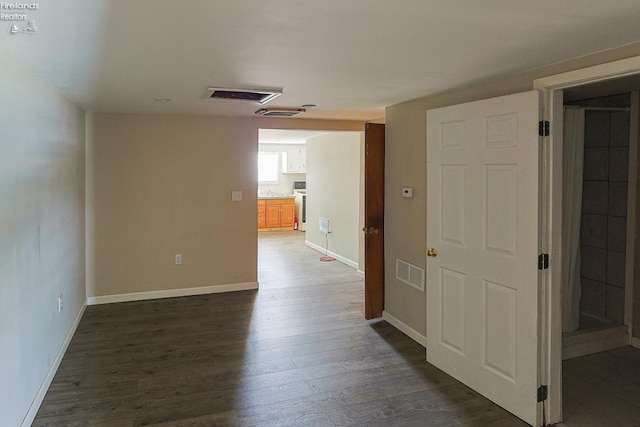 108 Spring St, Willard, OH 44890 - corridor featuring dark wood-type flooring and baseboards