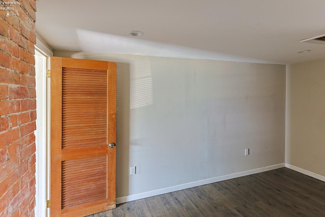 108 Spring St, Willard, OH 44890 - unfurnished room with wood finished floors and brick wall