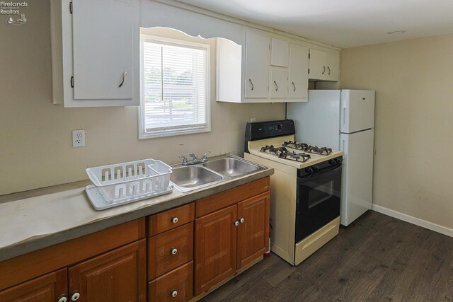 108 Spring St, Willard, OH 44890 - kitchen featuring range with gas cooktop, dark wood-style flooring, white cabinetry, brown cabinetry, and freestanding refrigerator