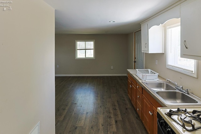 108 Spring St, Willard, OH 44890 - kitchen with dark wood-style floors, white range with gas stovetop, and brown cabinetry