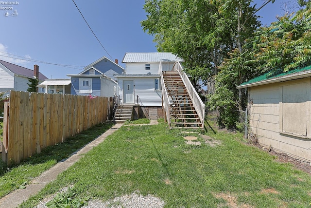 108 Spring St, Willard, OH 44890 - view of front of home featuring a metal roof, stairway, and an outbuilding