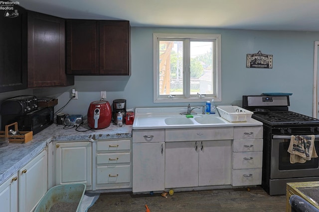 108 Spring St, Willard, OH 44890 - kitchen featuring stainless steel range with gas stovetop, light countertops, and dark wood-type flooring