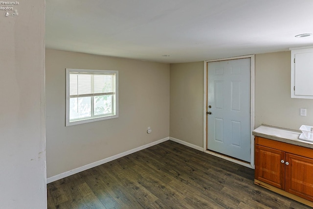 108 Spring St, Willard, OH 44890 - spare room with dark wood-style floors and baseboards