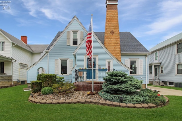 206 Lincoln Dr, Port Clinton, OH 43452 - view of front of property featuring a chimney, a front yard, and cooling unit