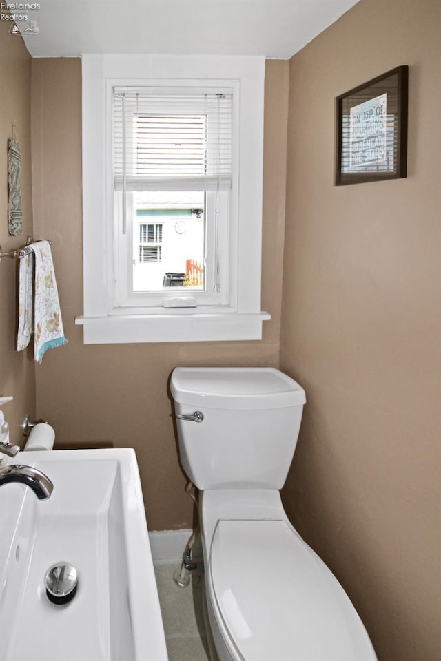 206 Lincoln Dr, Port Clinton, OH 43452 - half bath with toilet, a sink, and baseboards