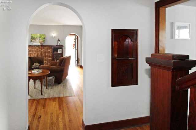 206 Lincoln Dr, Port Clinton, OH 43452 - hall featuring arched walkways, wood finished floors, and baseboards