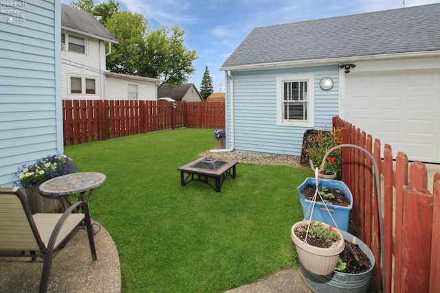 206 Lincoln Dr, Port Clinton, OH 43452 - view of yard featuring a fire pit and a garage