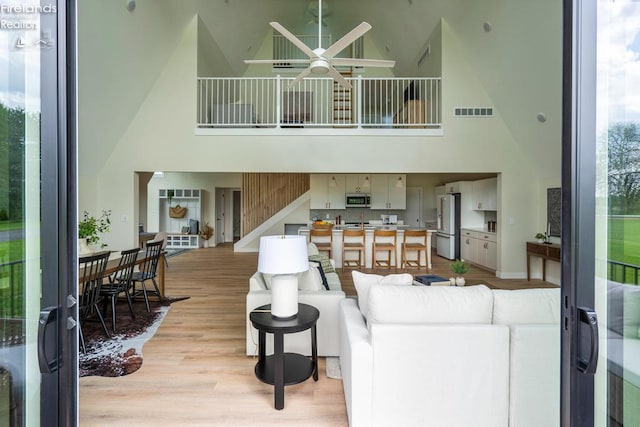 1861 N Opfer Lentz Rd, Martin, OH 43445 - living room with high vaulted ceiling, ceiling fan, and light wood-type flooring