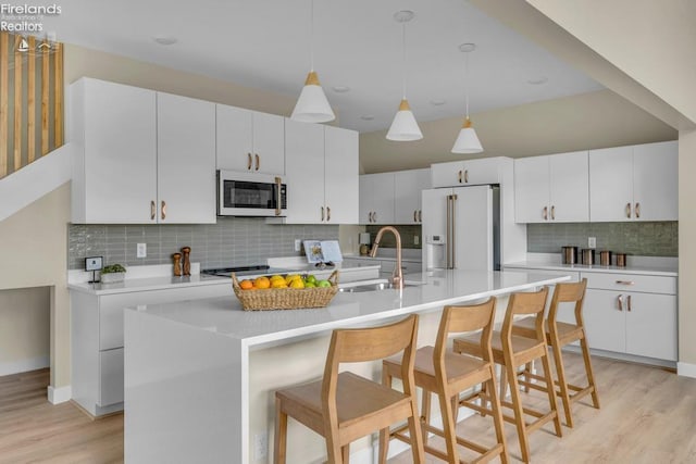 1861 N Opfer Lentz Rd, Martin, OH 43445 - kitchen with high end white refrigerator, a sink, light wood finished floors, tasteful backsplash, and light countertops