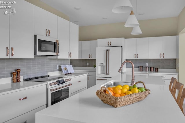 1861 N Opfer Lentz Rd, Martin, OH 43445 - kitchen featuring white appliances, a sink, light countertops, decorative backsplash, and decorative light fixtures