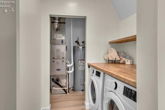 1861 N Opfer Lentz Rd, Martin, OH 43445 - washroom with electric water heater, washer and dryer, and light wood-style flooring