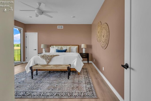 1861 N Opfer Lentz Rd, Martin, OH 43445 - bedroom featuring access to exterior, light wood-style floors, baseboards, and a ceiling fan