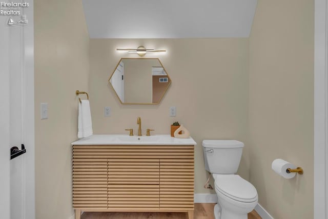 1861 N Opfer Lentz Rd, Martin, OH 43445 - bathroom featuring baseboards, toilet, vanity, and wood finished floors