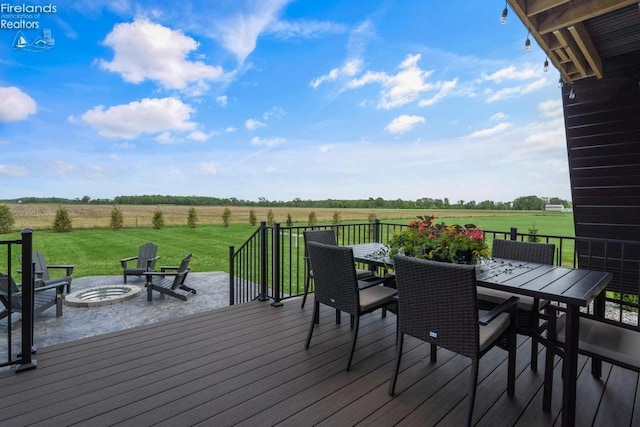1861 N Opfer Lentz Rd, Martin, OH 43445 - wooden deck featuring an outdoor fire pit, a rural view, outdoor dining area, and a yard