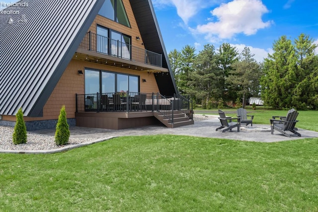 1861 N Opfer Lentz Rd, Martin, OH 43445 - back of house featuring a patio, a lawn, and a balcony