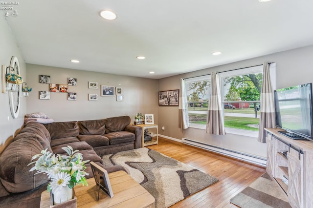 6518 W Township Road 112, Fostoria, OH 44830 - living area with a baseboard heating unit, light wood finished floors, and recessed lighting