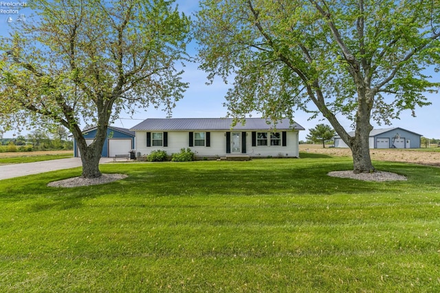 6518 W Township Road 112, Fostoria, OH 44830 - ranch-style house featuring a front lawn, driveway, metal roof, and a detached garage