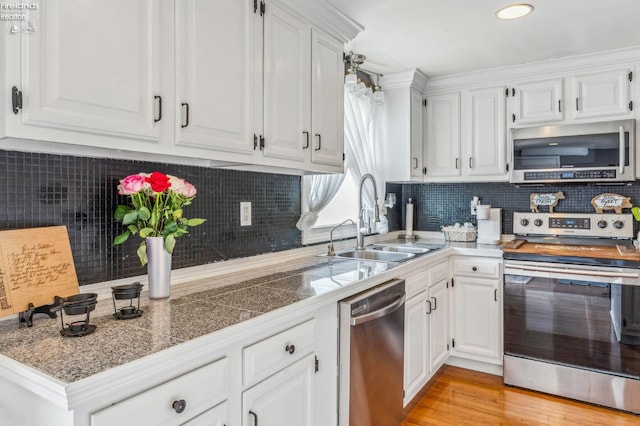 6518 W Township Road 112, Fostoria, OH 44830 - kitchen featuring stainless steel appliances, a sink, white cabinets, tasteful backsplash, and recessed lighting