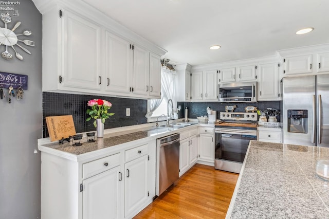 6518 W Township Road 112, Fostoria, OH 44830 - kitchen featuring stainless steel appliances, white cabinets, a sink, tile countertops, and recessed lighting