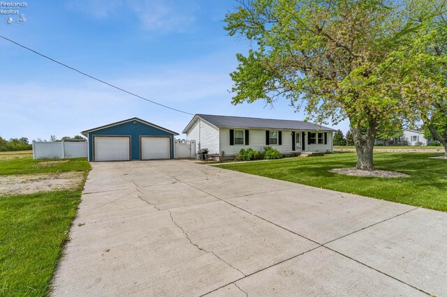 6518 W Township Road 112, Fostoria, OH 44830 - ranch-style house featuring a detached garage and an outbuilding