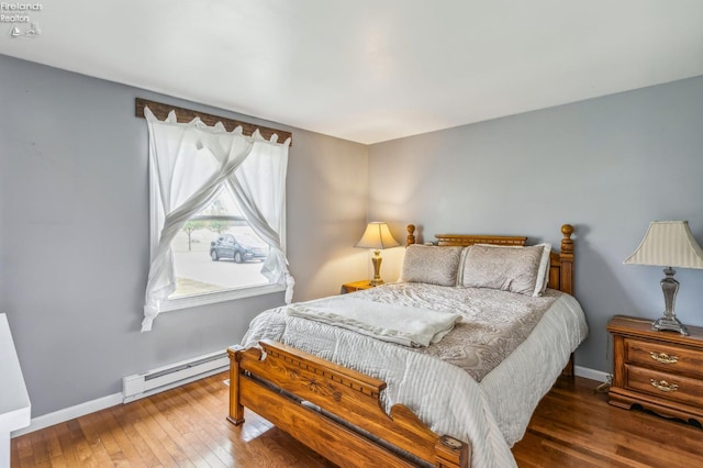 6518 W Township Road 112, Fostoria, OH 44830 - bedroom with baseboard heating, wood-type flooring, and baseboards