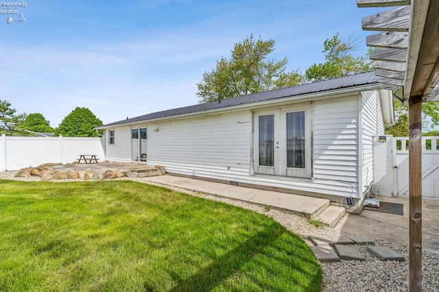 6518 W Township Road 112, Fostoria, OH 44830 - rear view of property featuring a patio, a gate, french doors, and metal roof