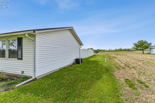 6518 W Township Road 112, Fostoria, OH 44830 - view of home's exterior with central AC unit, a yard, and a rural view