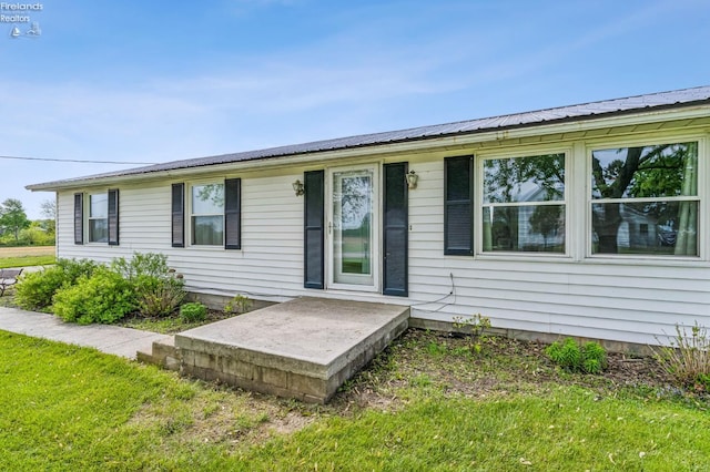 6518 W Township Road 112, Fostoria, OH 44830 - rear view of house with a yard and metal roof