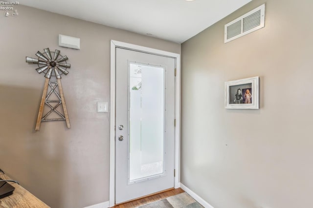 6518 W Township Road 112, Fostoria, OH 44830 - doorway to outside with wood finished floors and baseboards