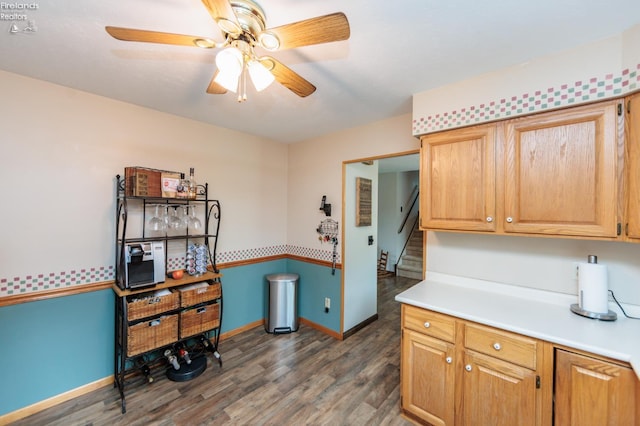 laundry room featuring a ceiling fan, wood finished floors, and baseboards