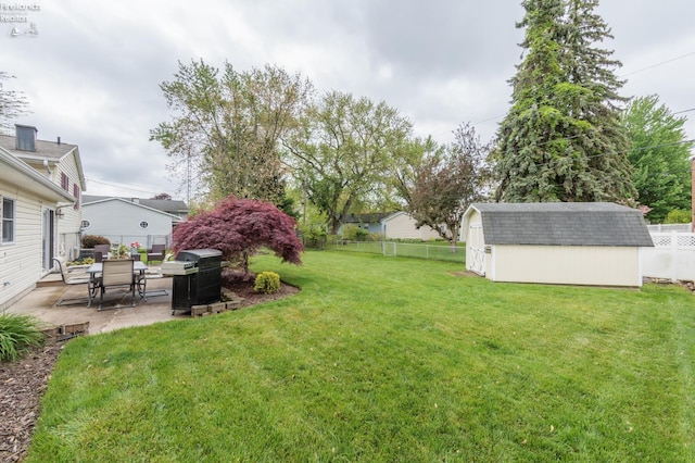 view of yard featuring a storage unit, a patio, and an outdoor structure
