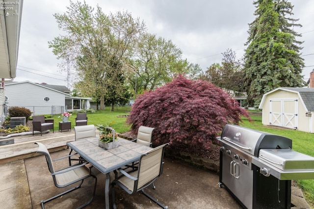 view of patio with grilling area, outdoor dining area, an outdoor structure, a storage unit, and a deck