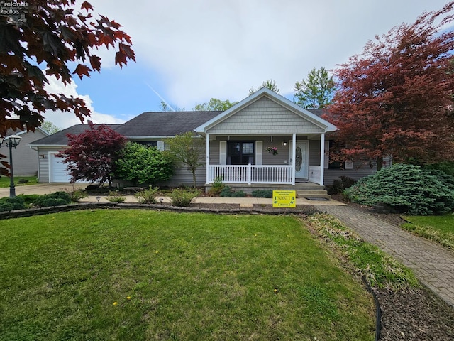 238 Nathan Dr, Clyde, OH 43410 - view of front of house featuring a porch, a front yard, and a garage
