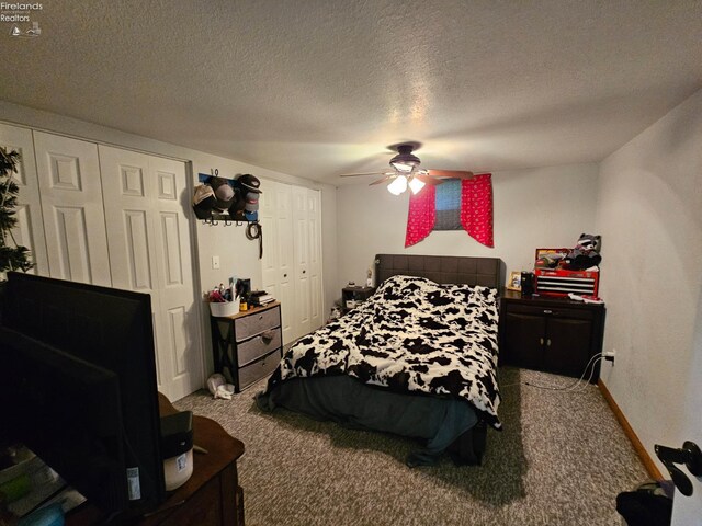 238 Nathan Dr, Clyde, OH 43410 - carpeted bedroom with multiple closets, a ceiling fan, a textured ceiling, and baseboards