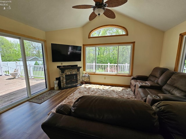 238 Nathan Dr, Clyde, OH 43410 - living room featuring healthy amount of natural light, ceiling fan, wood finished floors, lofted ceiling, and a stone fireplace