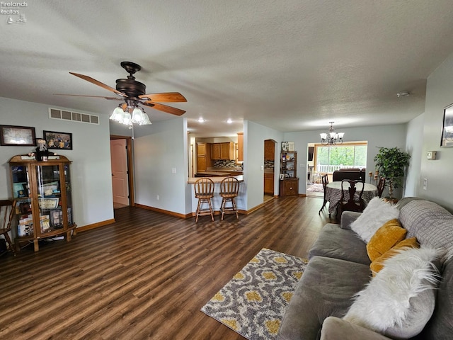 238 Nathan Dr, Clyde, OH 43410 - living area featuring a chandelier, dark wood-style flooring, a ceiling fan, a textured ceiling, and baseboards