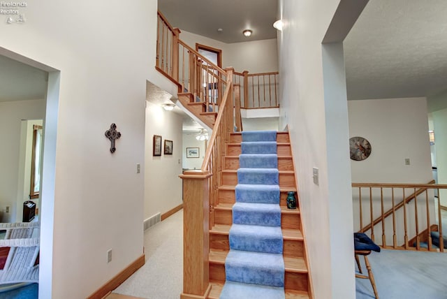 914 Wood Glen Ct, Norwalk, OH 44857 - staircase featuring carpet, baseboards, and a high ceiling