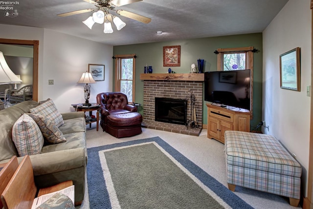 914 Wood Glen Ct, Norwalk, OH 44857 - living area featuring carpet, a fireplace, and a ceiling fan