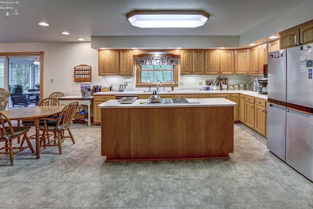 914 Wood Glen Ct, Norwalk, OH 44857 - kitchen with freestanding refrigerator, healthy amount of natural light, light countertops, a center island, and recessed lighting