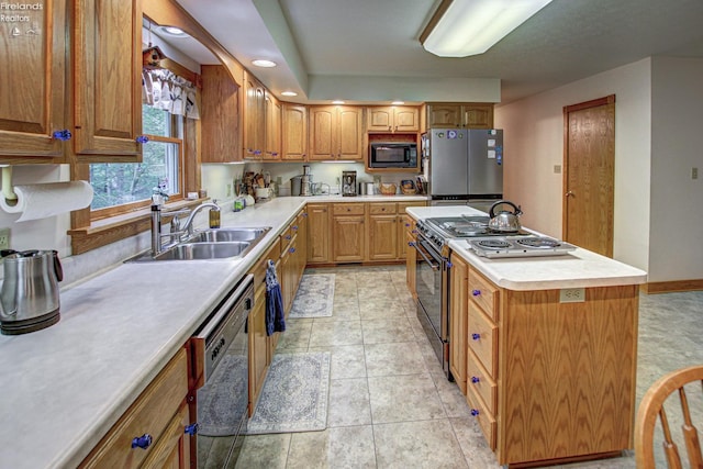 914 Wood Glen Ct, Norwalk, OH 44857 - kitchen with black appliances, a sink, a kitchen island, light countertops, and recessed lighting