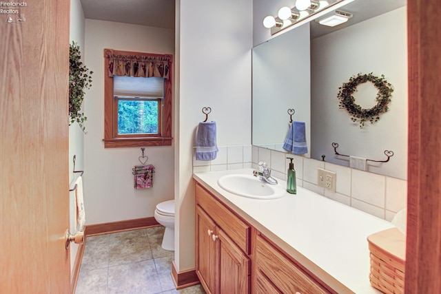 914 Wood Glen Ct, Norwalk, OH 44857 - bathroom with decorative backsplash, toilet, baseboards, vanity, and tile patterned floors