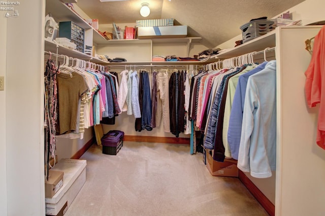 914 Wood Glen Ct, Norwalk, OH 44857 - spacious closet featuring carpet floors and vaulted ceiling