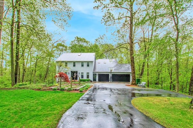 914 Wood Glen Ct, Norwalk, OH 44857 - view of front facade with driveway, a front lawn, metal roof, and a garage