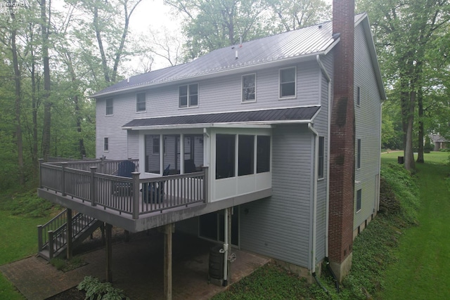 914 Wood Glen Ct, Norwalk, OH 44857 - back of house featuring a wooden deck, a chimney, metal roof, and central AC