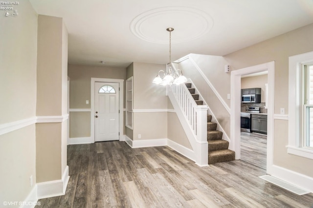 509 College Ave, Fostoria, OH 44830 - foyer with wood finished floors, stairway, and healthy amount of natural light