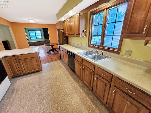 110 Orchard Grove Dr, Clyde, OH 43410 - kitchen featuring a sink, black dishwasher, light countertops, and brown cabinetry